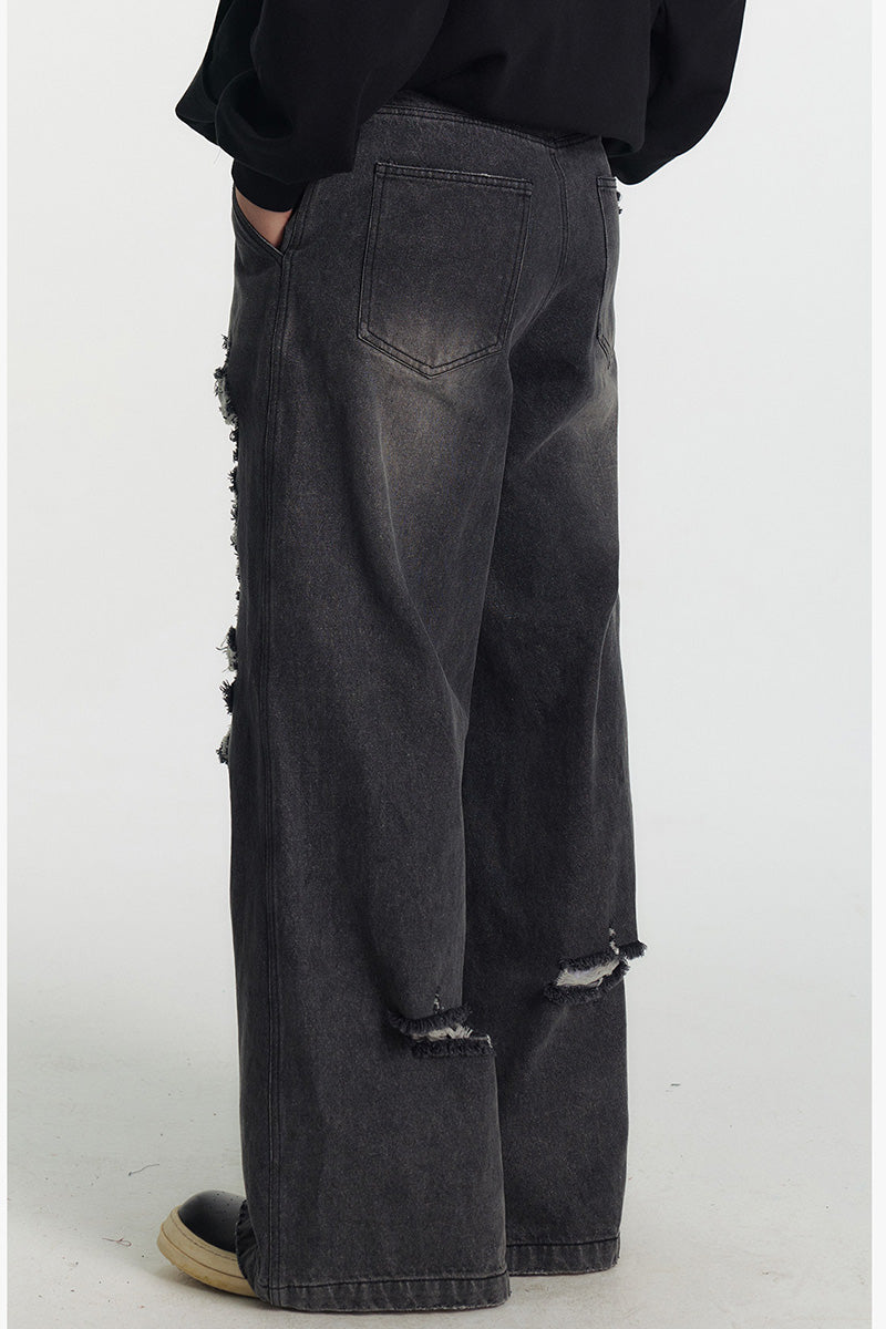 Jean femme oversize délavé à déchirures, coupe large et longue style streetwear tendance