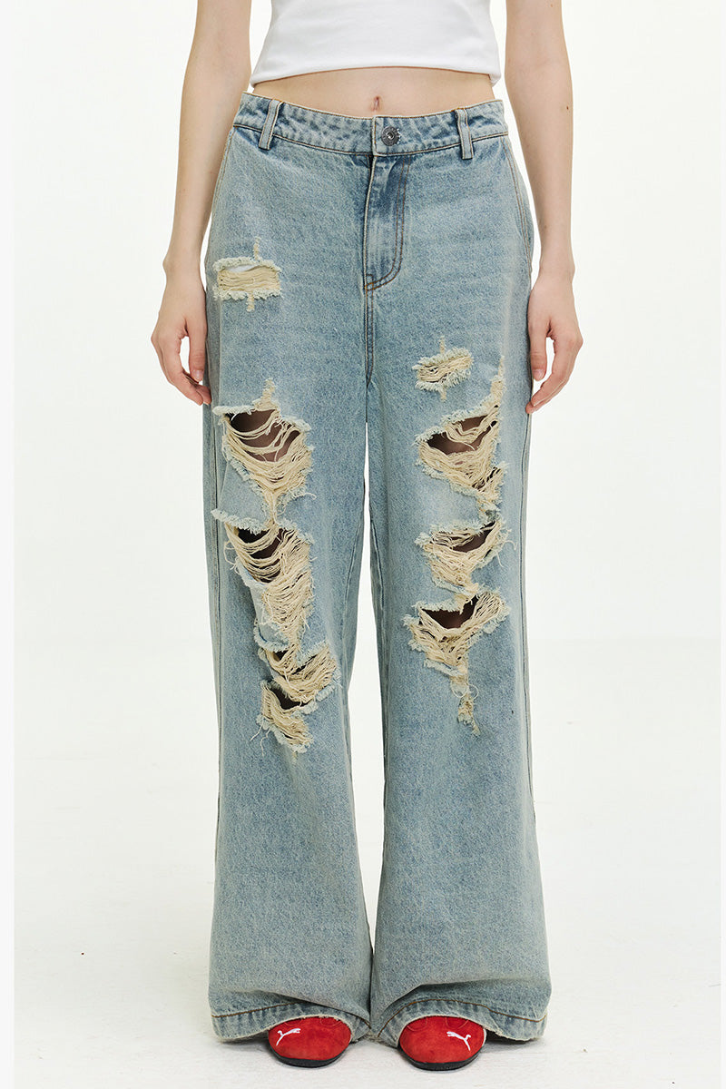Jean femme oversize délavé à déchirures, coupe large et longue style streetwear tendance